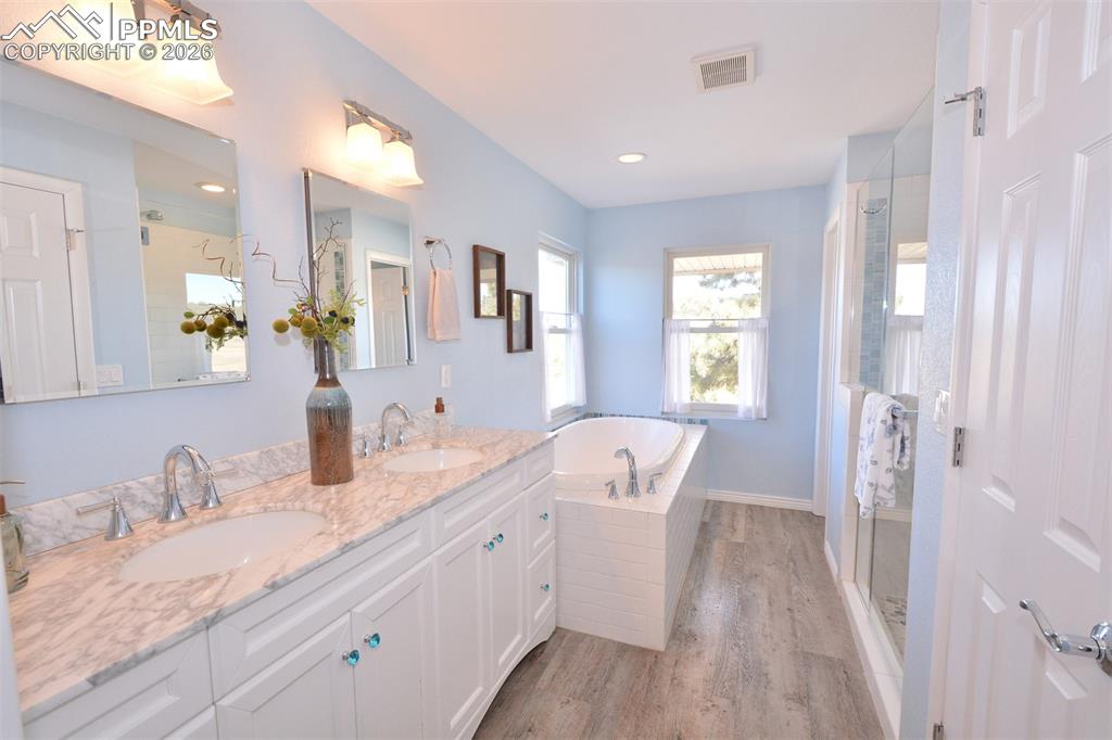 Image 28 of 50: Master Bathroom with double vanity, spa shower with bench seat and soaking