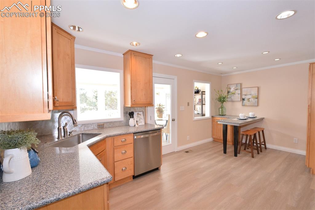 Image 9 of 50: Kitchen with plenty of cabinets, stainless appliances and breakfast nook.