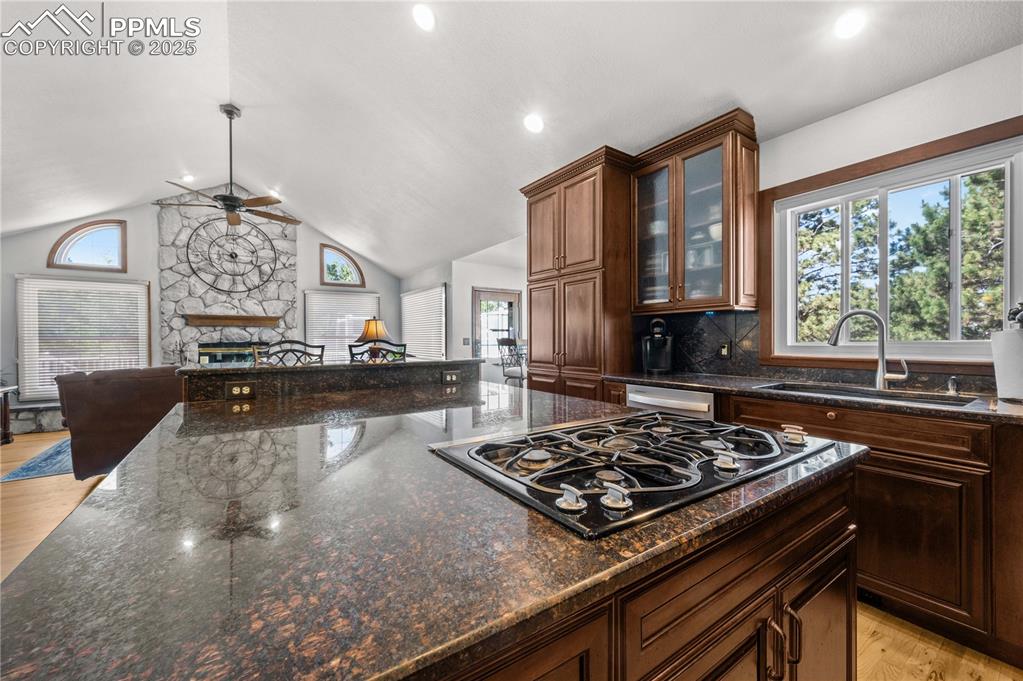 Image 4 of 33: Updated oversized kitchen, with a large Granite Island and glass display ca