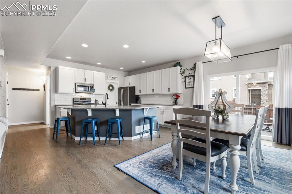 Image 10 of 43: Dining room featuring recessed lighting and dark wood finished floors