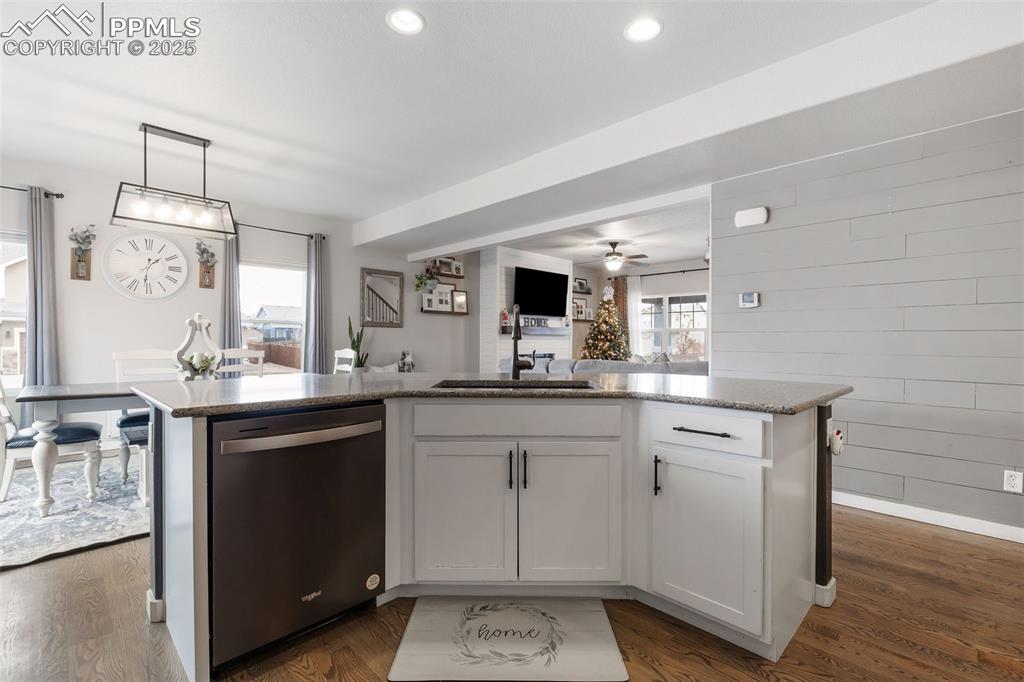 Image 14 of 43: Kitchen featuring decorative light fixtures, open floor plan, dishwasher, w