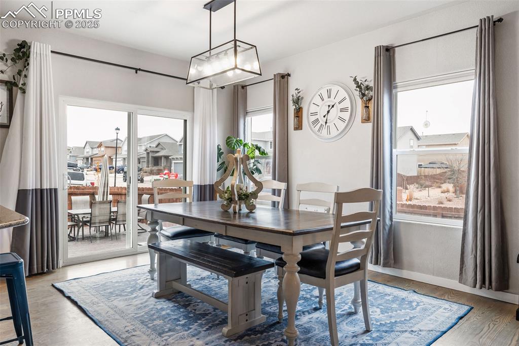 Image 15 of 43: Dining space with light wood finished floors and baseboards