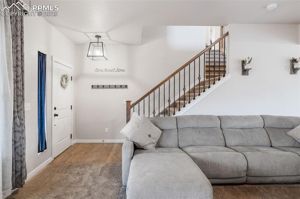 Image 5 of 43: Living room featuring stairs and baseboards