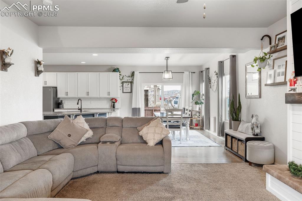 Image 9 of 43: Living room featuring recessed lighting, a ceiling fan, and light wood fini