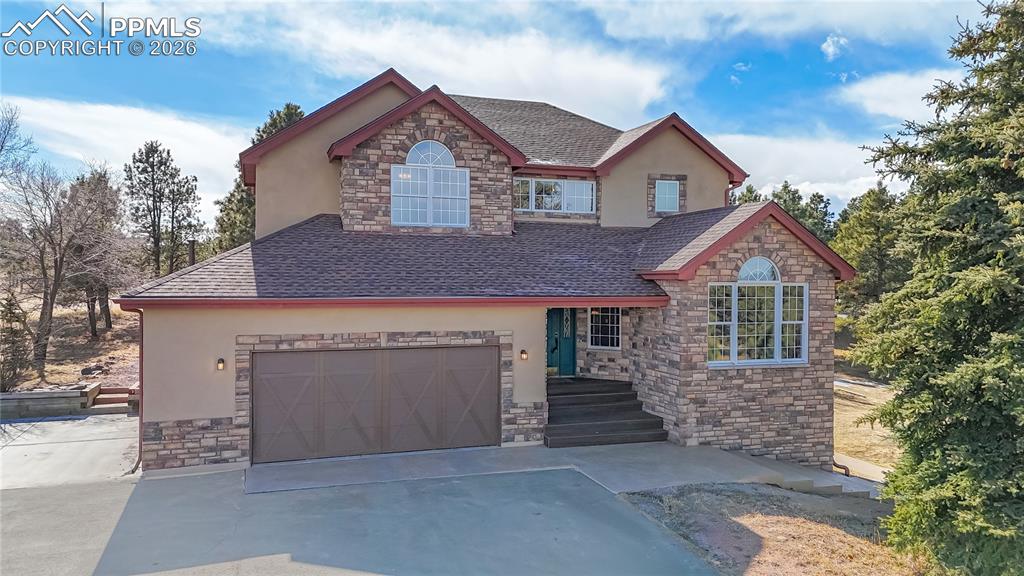 Image 1 of 50: View of front of property featuring stone siding, roof with shingles, and s