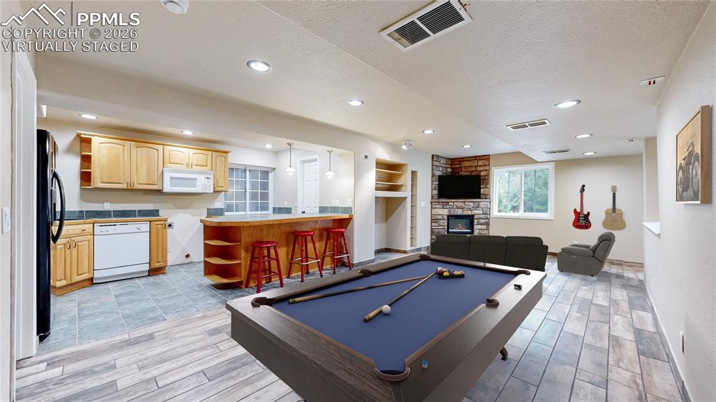 Image 26 of 50: Virtually Staged basement recreation area