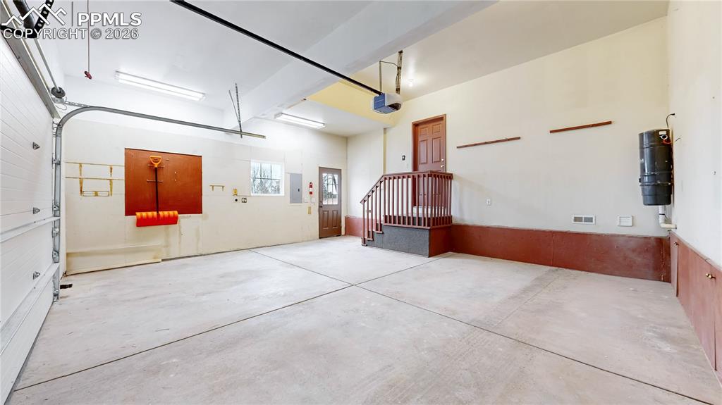 Image 38 of 50: Garage with a central vacuum unit