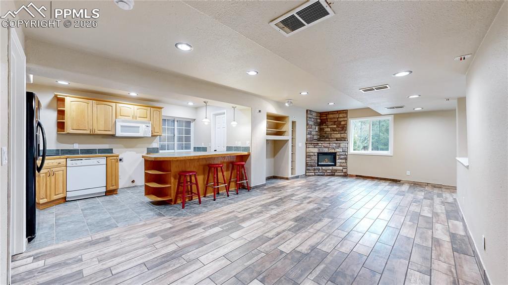 Image 46 of 50: View from basement recreation room to kitchenette