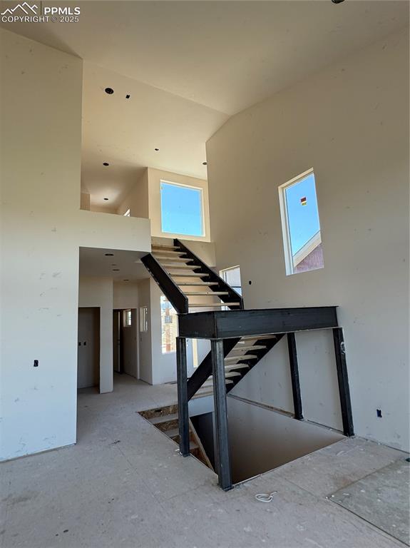 Image 4 of 9: Stairs featuring a towering ceiling