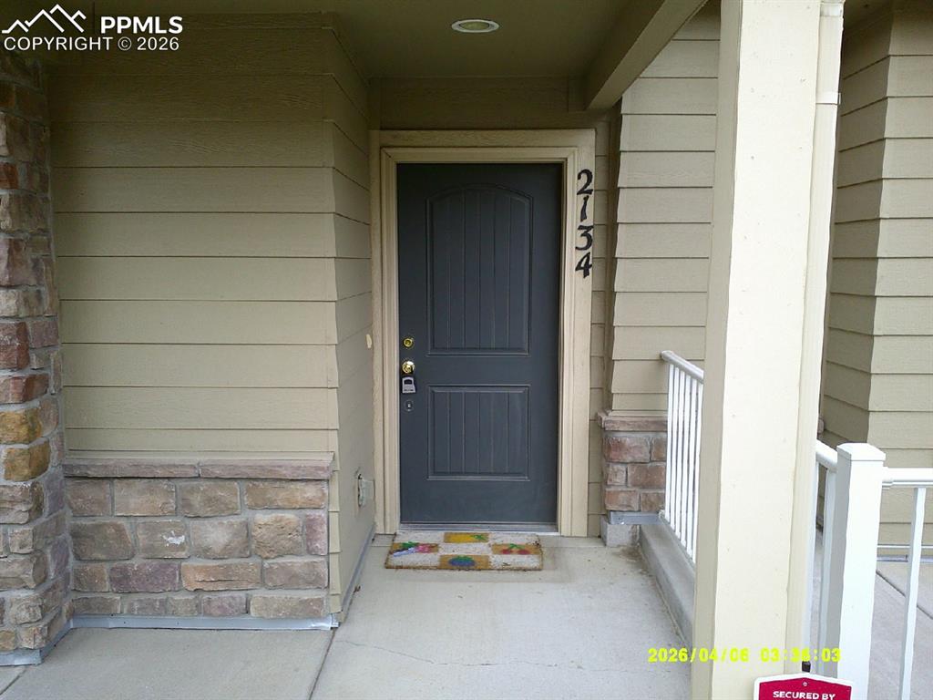 Image 1 of 13: The property features a dark gray front door with visible house numbers, co