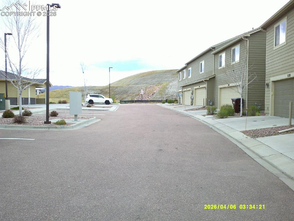 Image 13 of 13: This property features a multi-story exterior with siding and attached gara