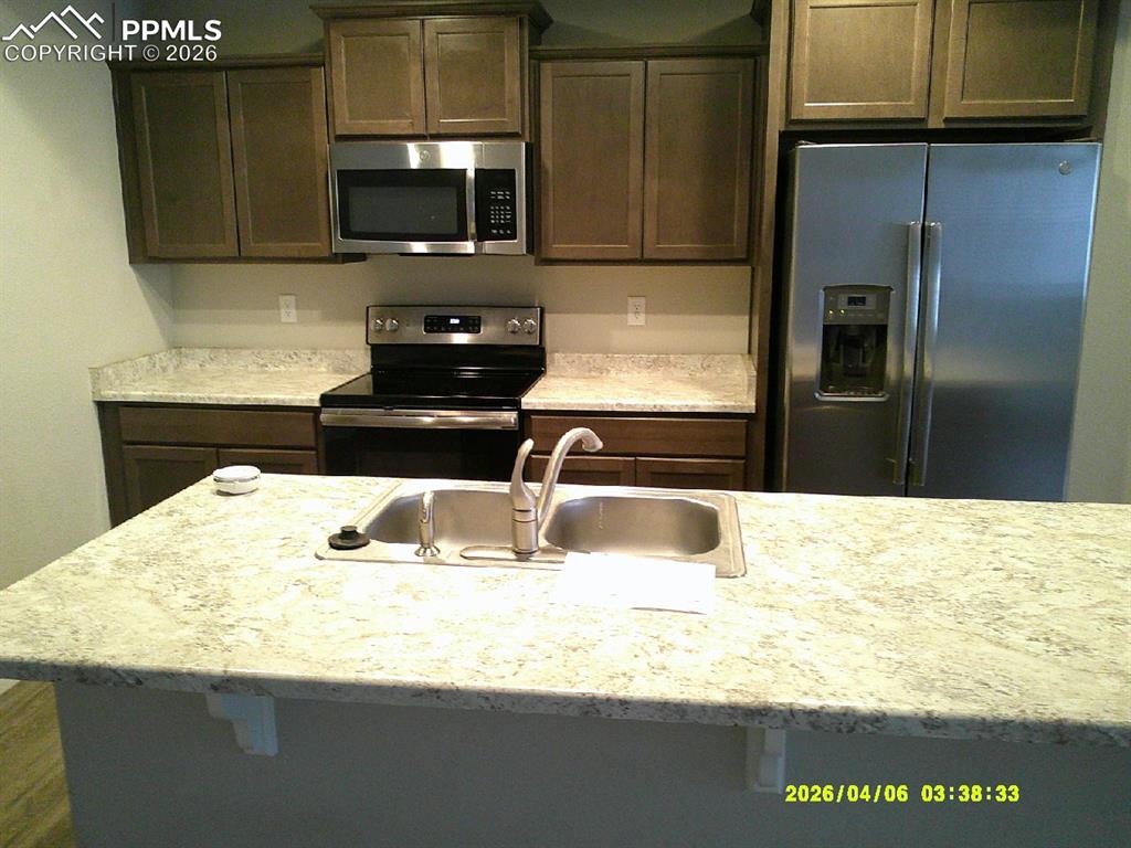 Image 3 of 13: Well-appointed kitchen featuring granite-style countertops, stainless steel