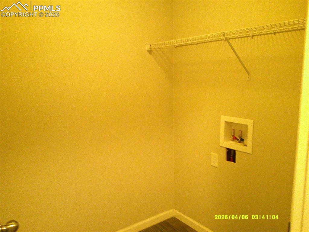 Image 7 of 13: The property includes a dedicated laundry area with a utility hookup and a 