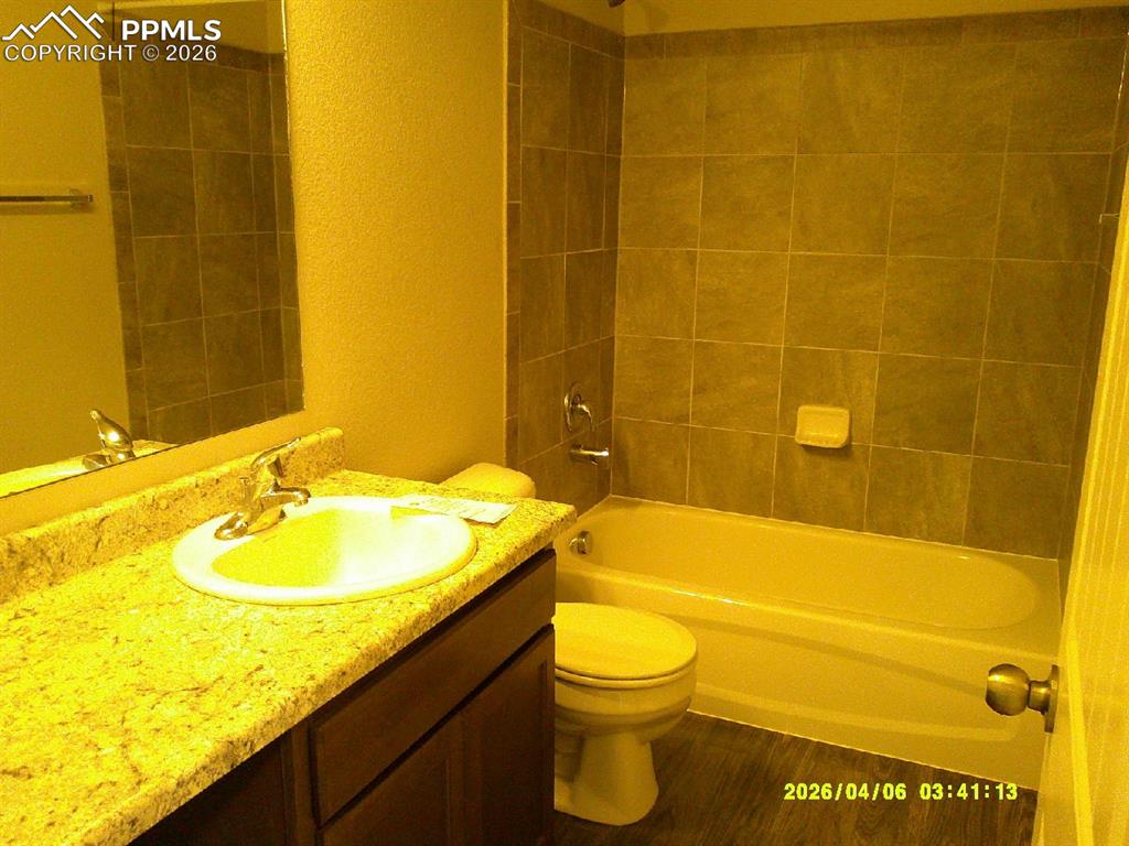 Image 8 of 13: Bathroom featuring a vanity with a light-colored countertop, an integrated 