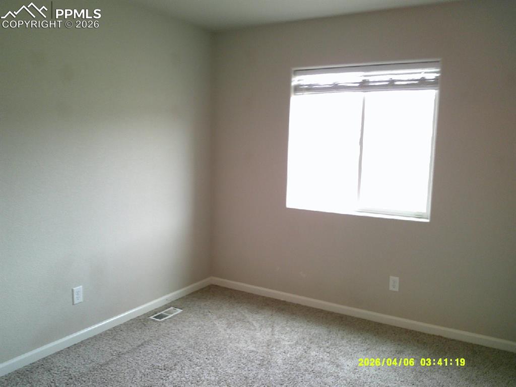 Image 9 of 13: Room featuring light-colored walls and carpeted flooring