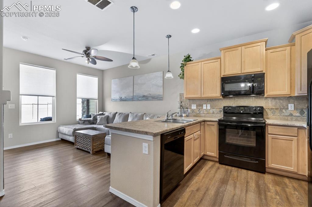 Image 15 of 42: Open view from kitchen/dining area, to the livingroom area