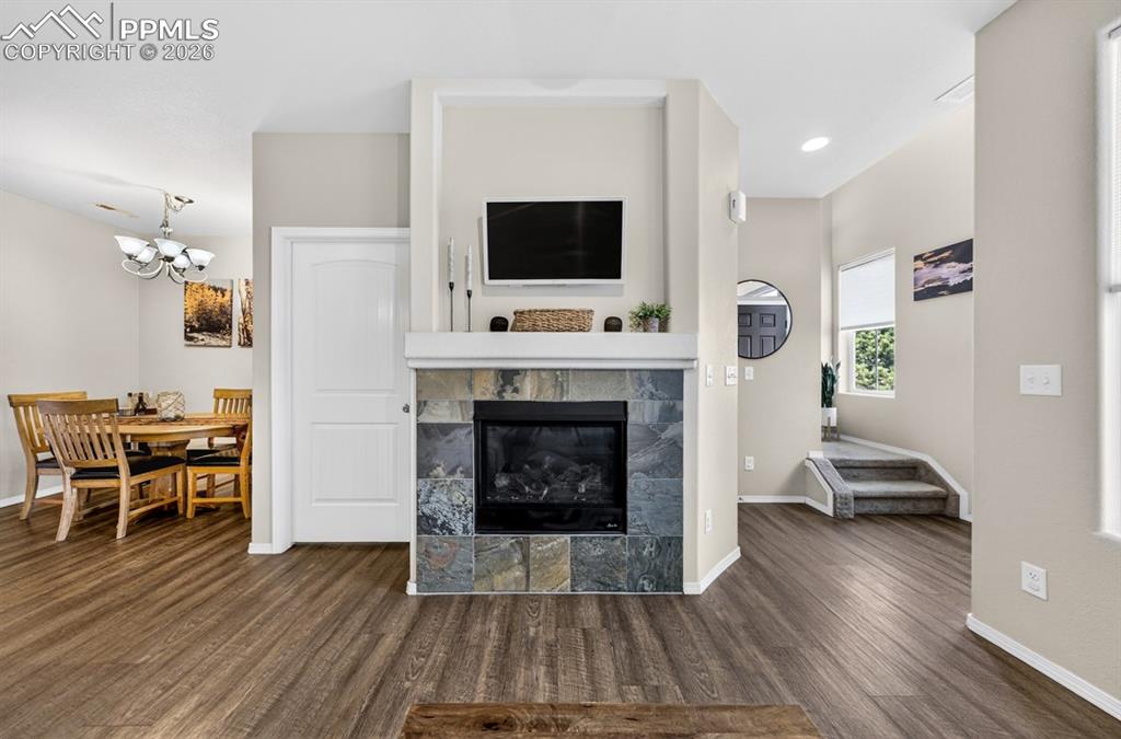 Image 22 of 42: Main door enters from the right. Steps lead to the upstairs