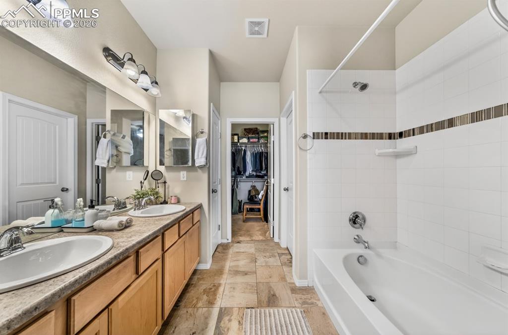 Image 28 of 42: Large soaking tub, double sinks and walk-in closet