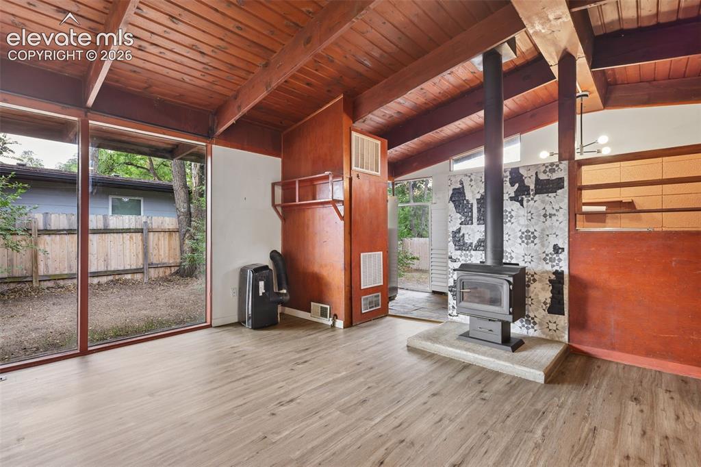 Image 12 of 36: Vaulted wood-paneled ceilings with exposed beams, full-height windows, wood
