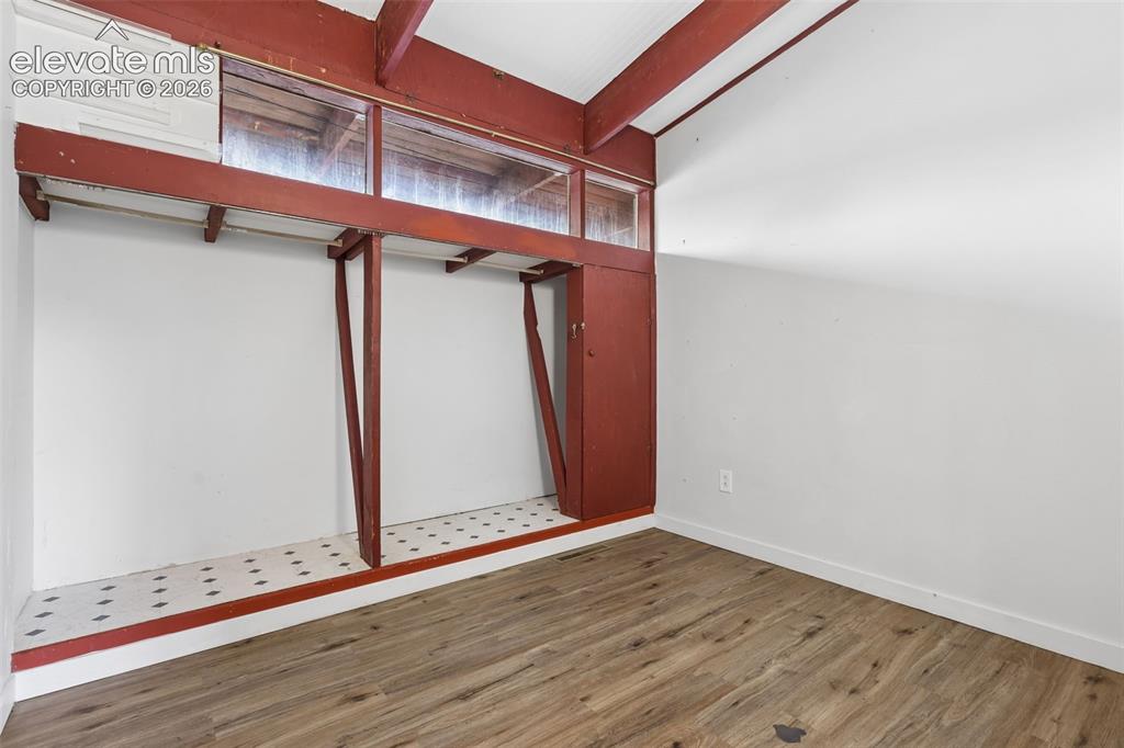 Image 19 of 36: Wood-finish flooring with white painted walls