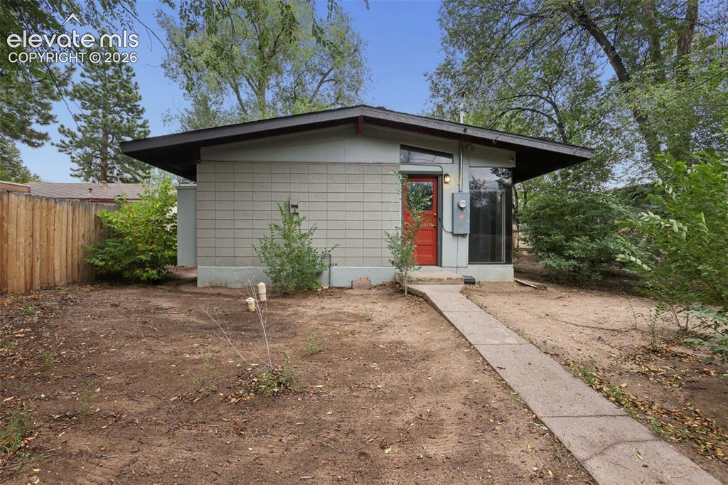 Image 25 of 36: Mid-century modern architecture with a low-slope roofline, a striking red e