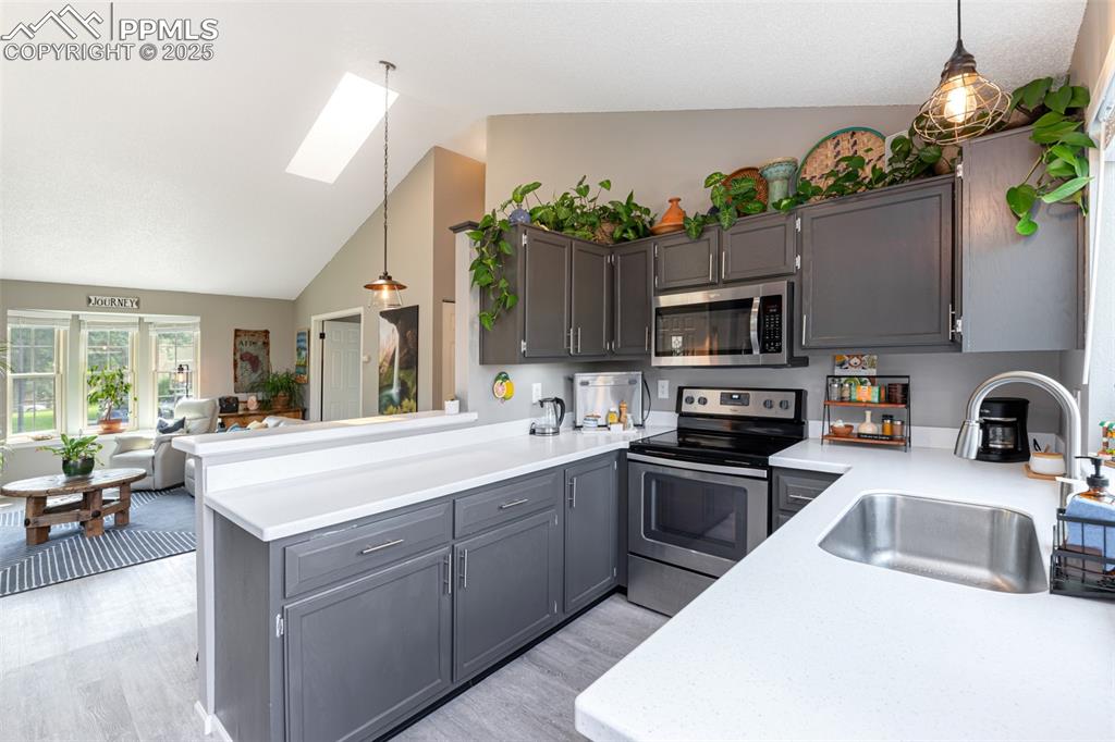 Image 12 of 27: Kitchen with deep sink and plenty of countertop space and storage.