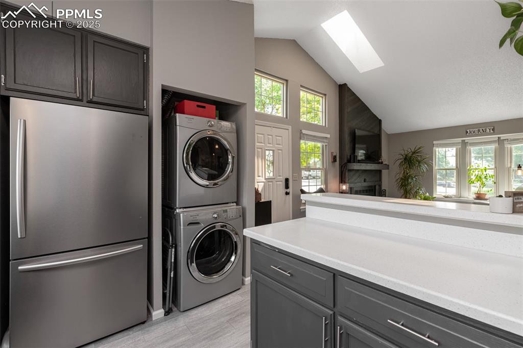 Image 13 of 27: Electric Laundry area with stacked washer / drying machine, brand new refri