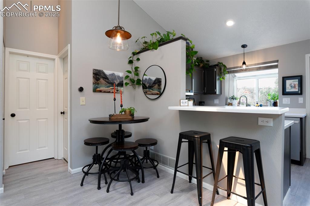 Image 14 of 27: Nook and bar with door to bedroom and bathroom