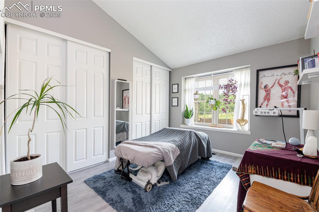 Image 17 of 27: Primary Bedroom currently used for massage therapy. Two closets with access