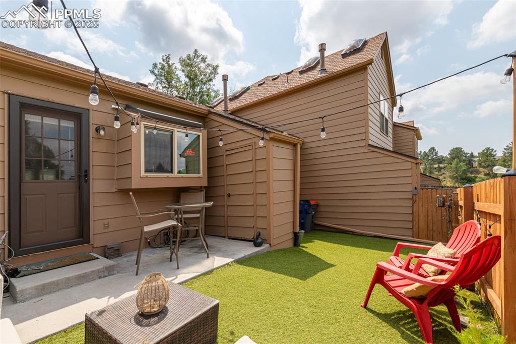 Image 21 of 27: Back of house with a patio area and a gate