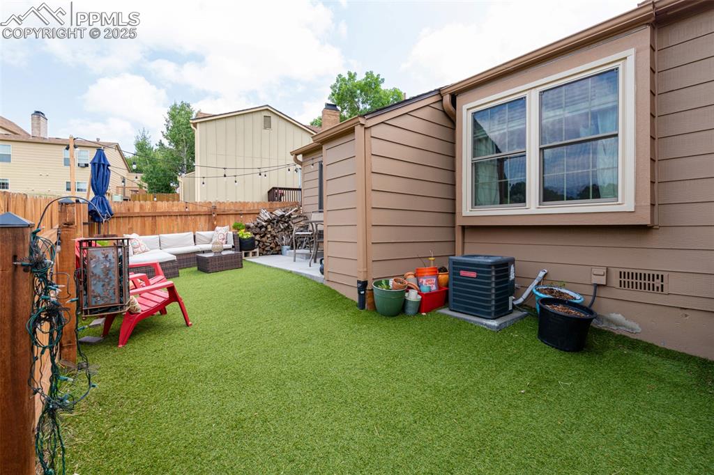 Image 22 of 27: Fenced yard featuring outdoor lounge area and a patio area