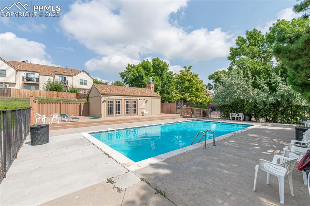 Image 26 of 27: View of swimming pool with a wooden deck, a patio, an outdoor structure, an