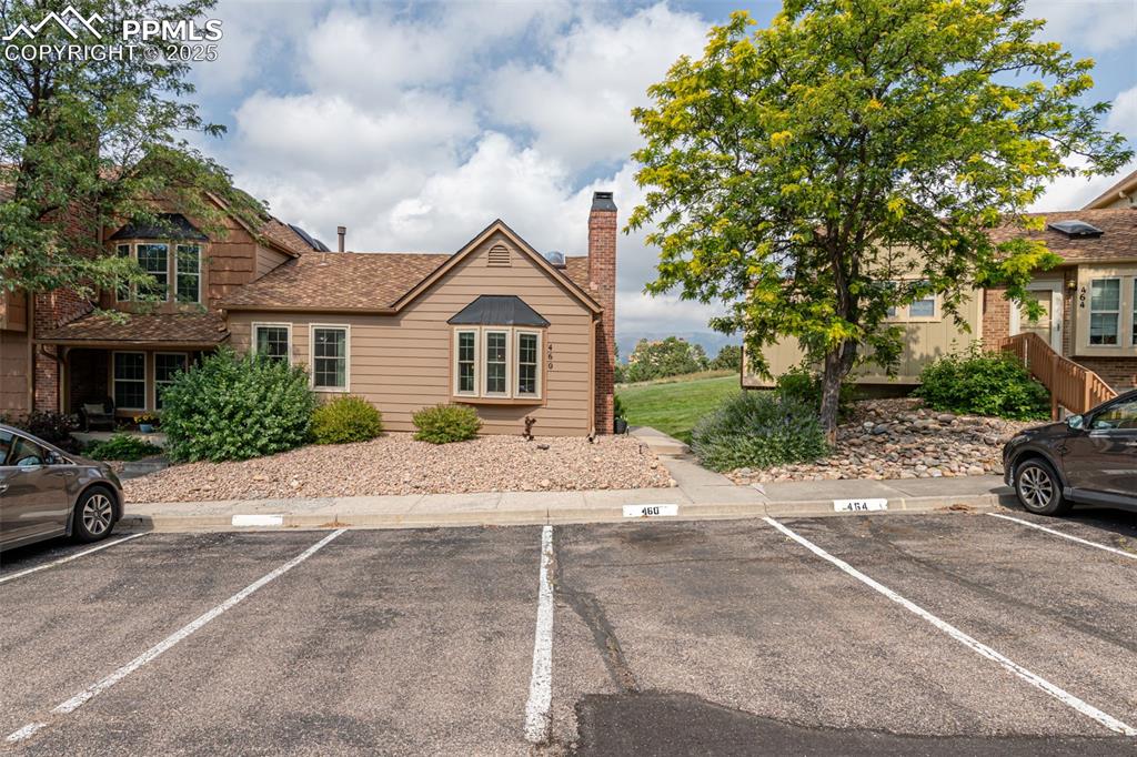 Image 5 of 27: View of front of property featuring one assigned parking space with plenty