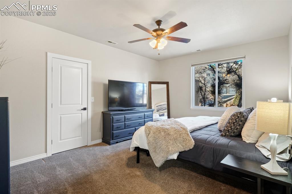 Image 28 of 37: Bedroom featuring ceiling fan and carpet floors