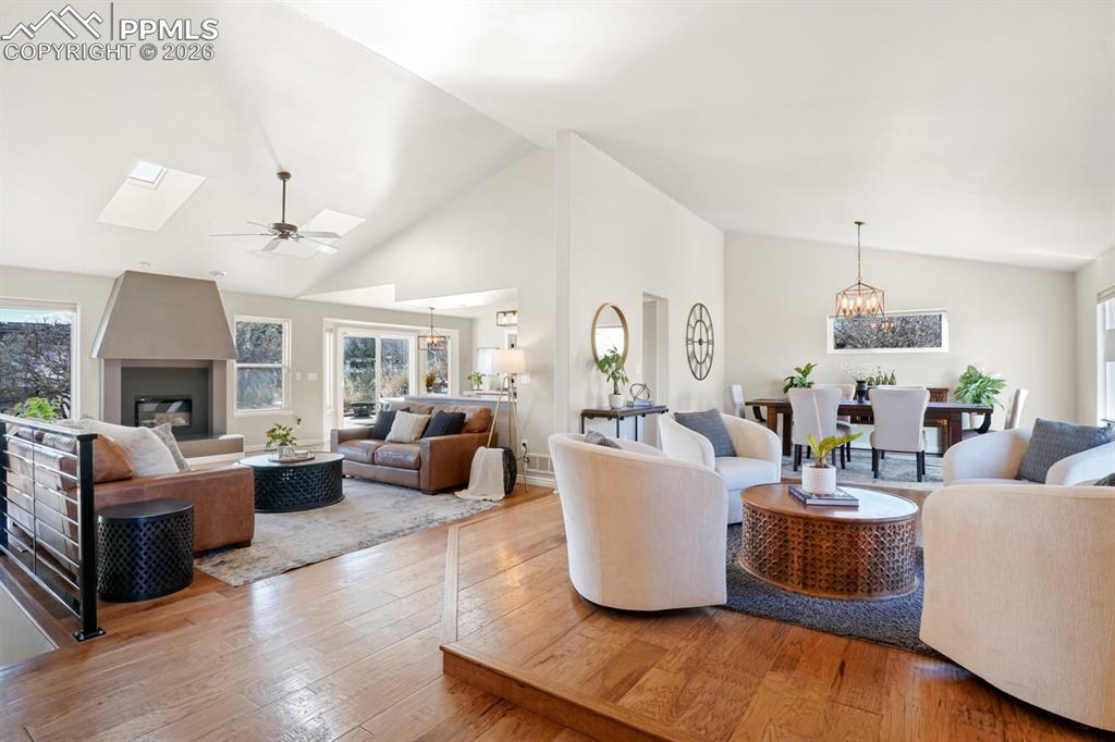 Image 3 of 37: Living room with a wealth of natural light, a large fireplace, hardwood / w