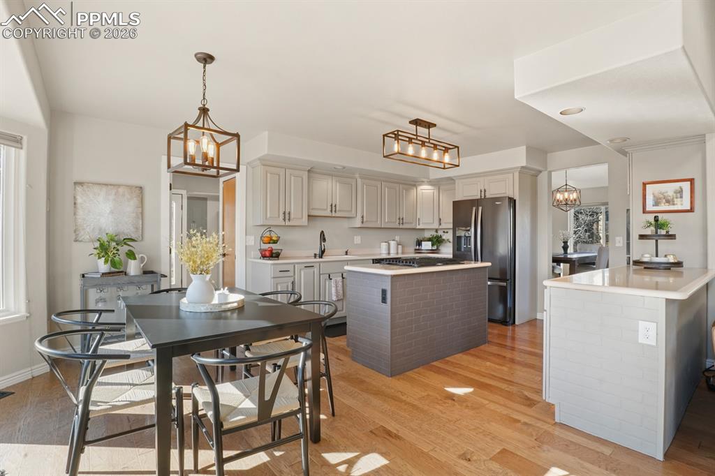 Image 7 of 37: Kitchen with a notable chandelier, light hardwood / wood-style flooring, st