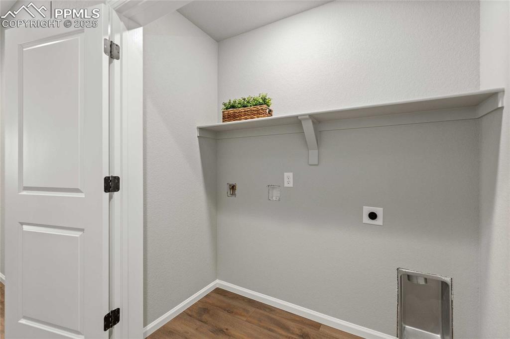Image 16 of 27: Washroom featuring dark wood-style floors, washer hookup, hookup for an ele