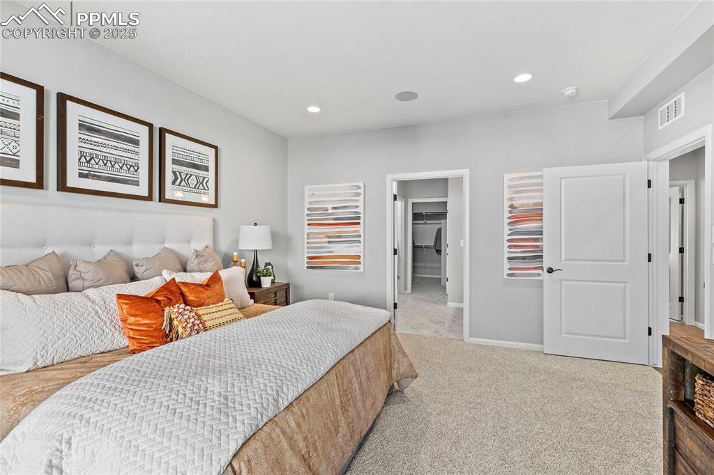 Image 21 of 27: Carpeted bedroom featuring a walk in closet and recessed lighting