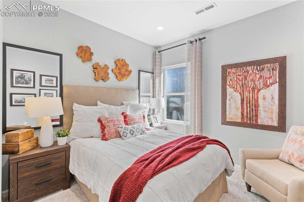 Image 27 of 27: Carpeted bedroom with recessed lighting