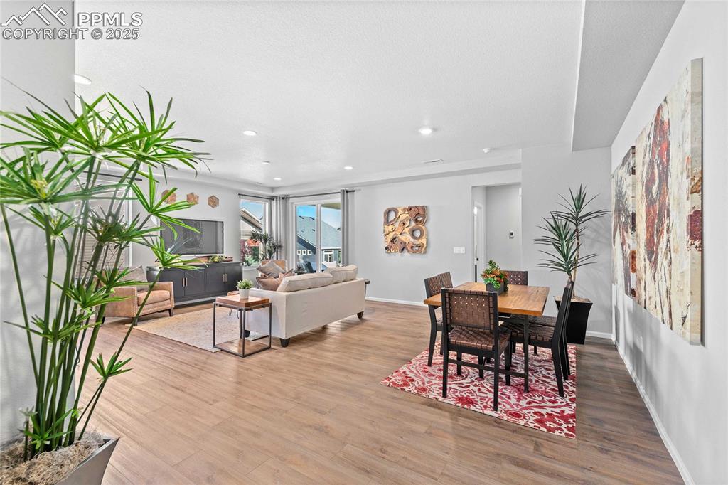 Image 4 of 27: Dining area with light wood-type flooring and recessed lighting