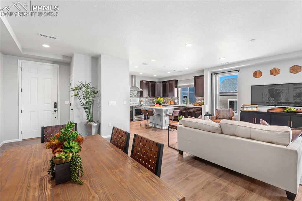 Image 6 of 27: Dining room featuring light wood finished floors, recessed lighting, and a 
