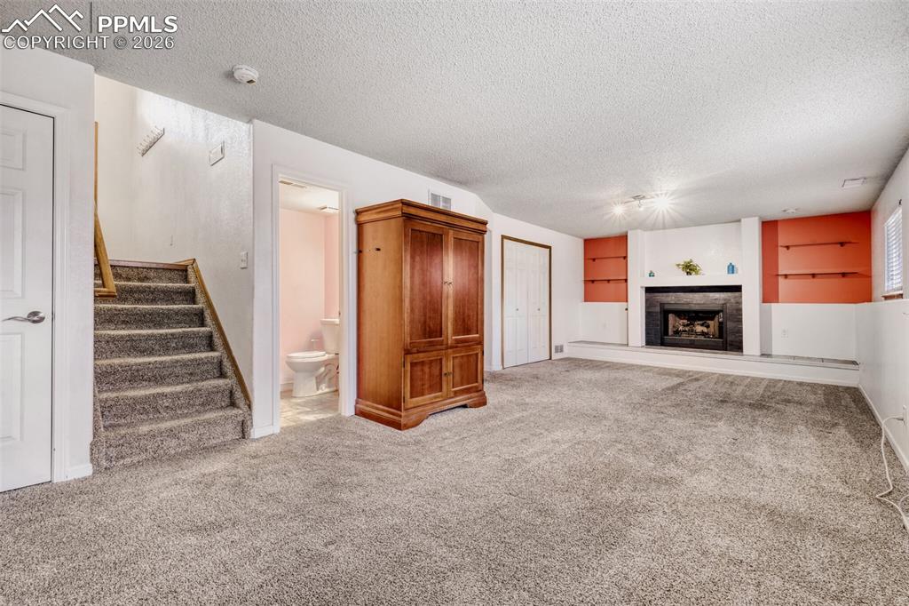 Image 14 of 17: Lower Level Living Room - Cozy Fireplace! 