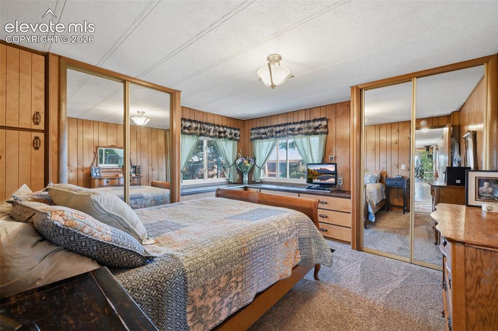 Image 27 of 50: Wood-paneled walls and ceiling-mounted light fixture