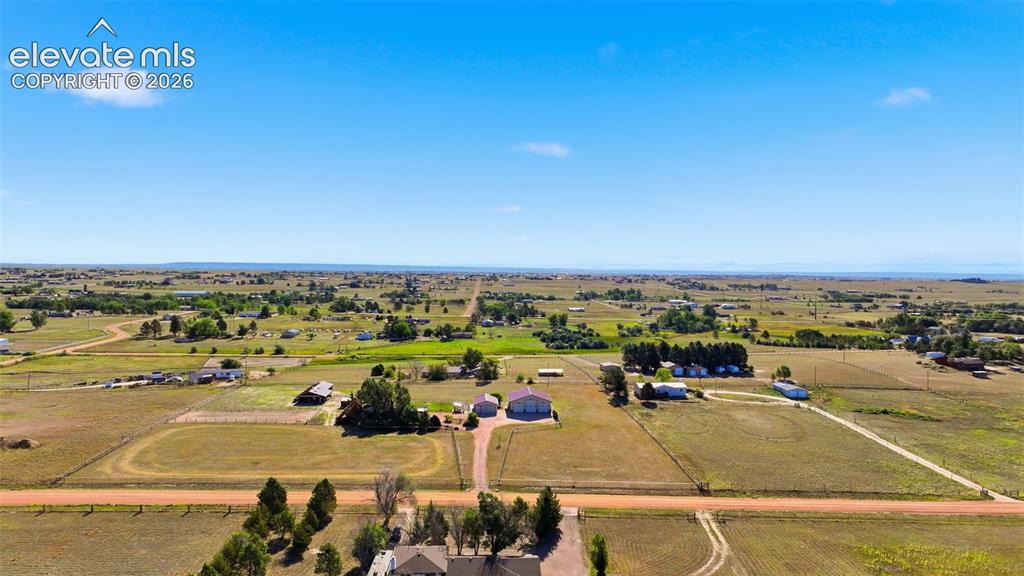 Image 4 of 50: Expansive property featuring multiple structures, open fields, and establis