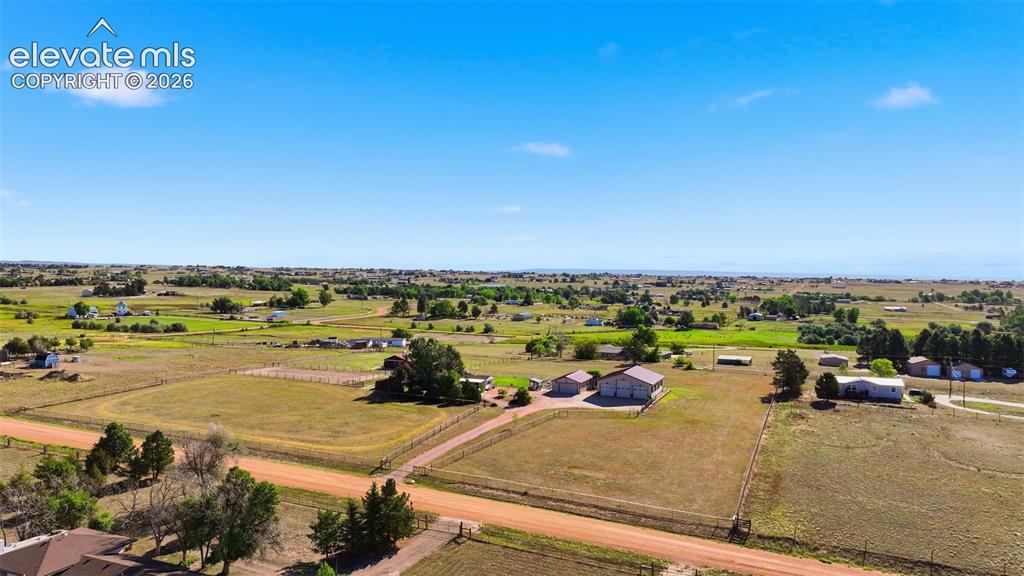 Image 5 of 50: Expansive rural landscape with multiple residential structures, outbuilding