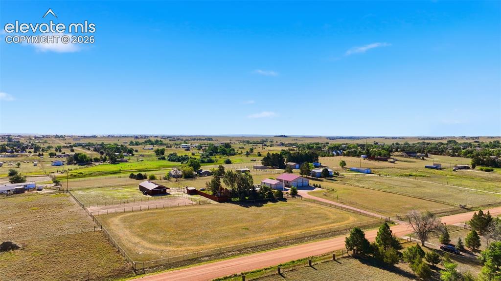 Image 6 of 50: Expansive rural property featuring multiple structures, fenced paddocks, an