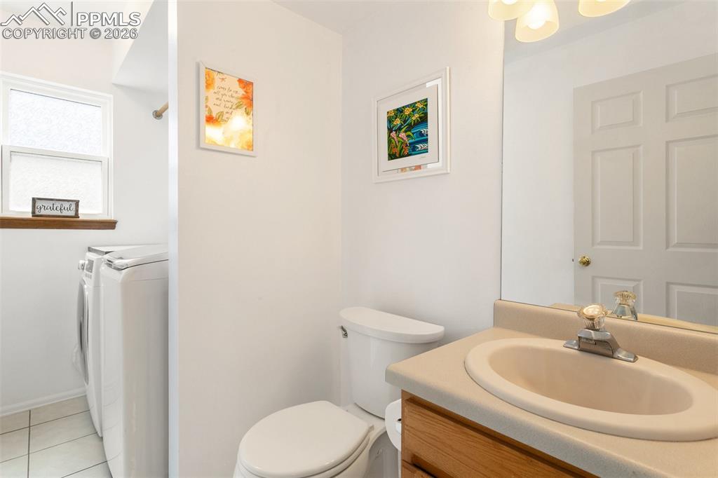Image 19 of 36: Half bath and laundry off the family room just in from the garage.