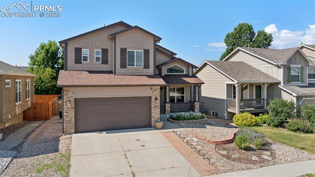 Image 2 of 38: Craftsman-style home featuring concrete driveway, a garage, stone siding, a