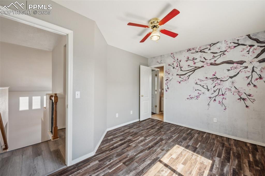 Image 27 of 38: Spare room featuring wood finished floors and ceiling fan