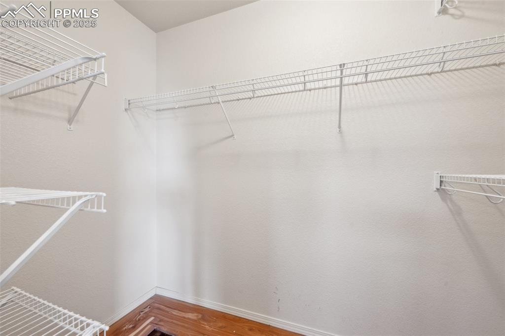 Image 32 of 38: Walk in closet featuring wood finished floors